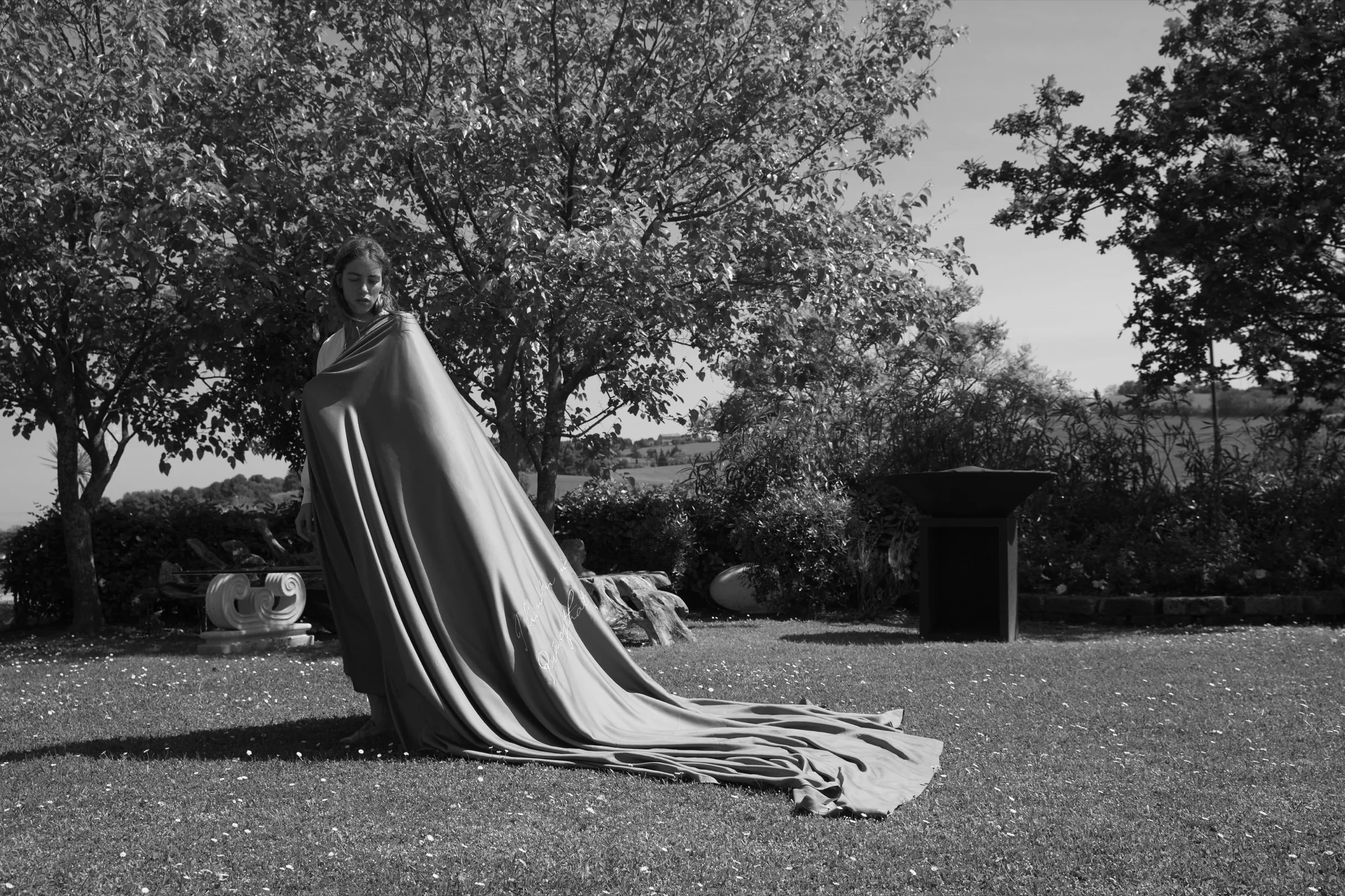 A model wrapped in flowing Autentica Fibra di Legno cloth outdoors