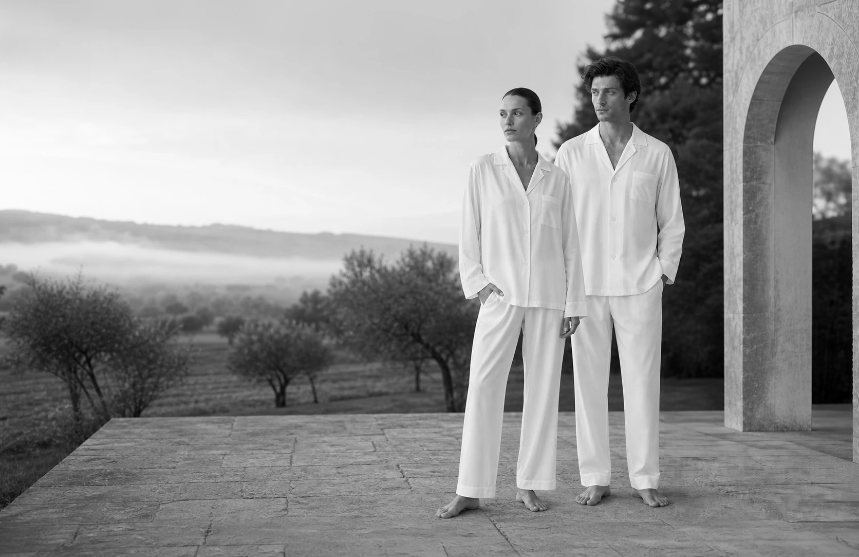 Woman and man wearing white Beltrami pyjamas in the countryside